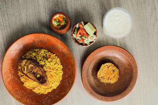 Hilsa Khichuri Combo with salad, eggplant, borhani and boondi rabi served in dish isolated on mat top view of indian and bangladeshi food photo