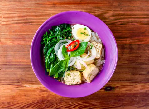 vegetarian rice noodles with boiled egg, onion and mint served in dish isolated on wooden table top view of hong kong food photo