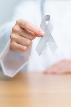 Brain Cancer Awareness May month, Doctor with grey color Ribbon for supporting life people. Healthcare and World cancer day concept photo