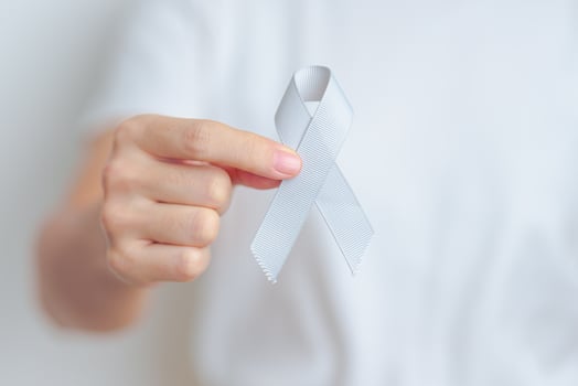 Brain Cancer Awareness May month, woman with grey color Ribbon for supporting life people. Healthcare and World cancer day concept photo