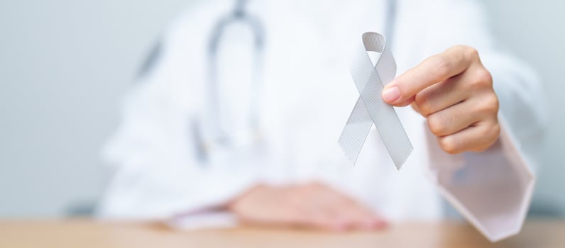 Brain Cancer Awareness May month, Doctor with grey color Ribbon for supporting life people. Healthcare and World cancer day concept photo
