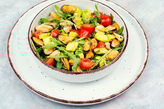 Healthy salad with mussels, herbs and vegetables. photo