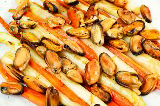 Delicious mussels with asparagus, tasty salad. photo