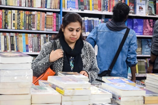 New Delhi, India, February 17 2024 - Variety of Books on shelf inside a book-stall at Delhi International Book Fair, Selection of books on display in Annual Book Fair at Bharat Mandapam complex photo