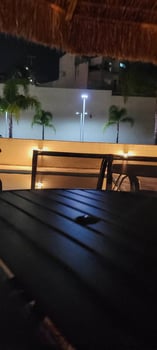 image of dark table in garden with pool at night photo