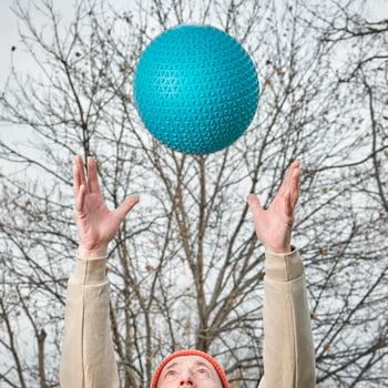 senior man is throwing a heavy slam ball photo