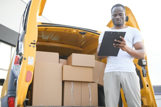 Delivery man near shipping mini van. photo