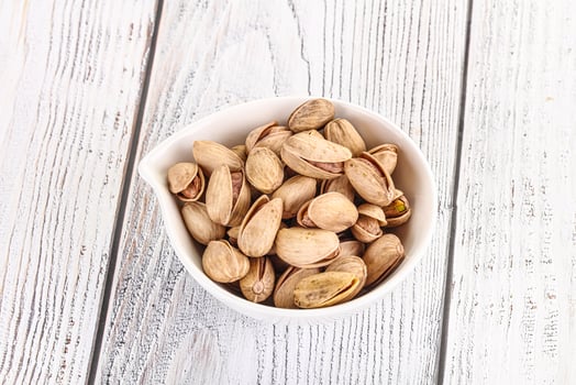 Salted tasty pistachio nuts heap photo