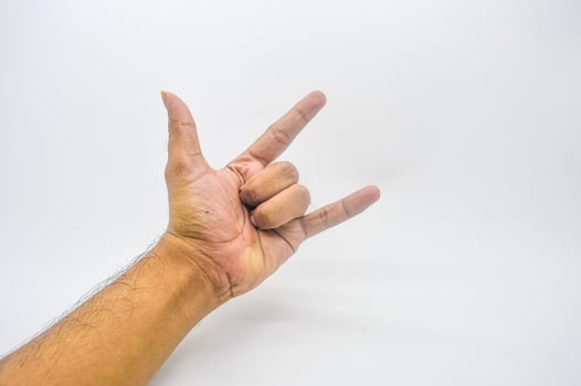 metal hand gesture isolated on white background photo