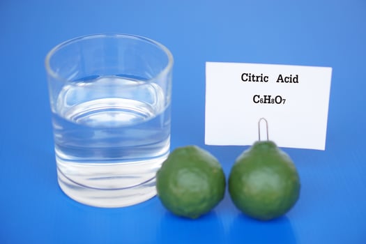 Transparent glass of water and fruits to do science experiment about Citric Acid with molecular formula C6H8O7 from fruits. Concept, Education, Science laboratory lesson. photo
