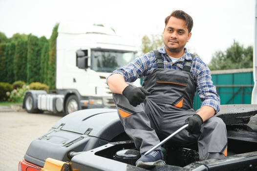 Indian Mechanic repairing the truck photo