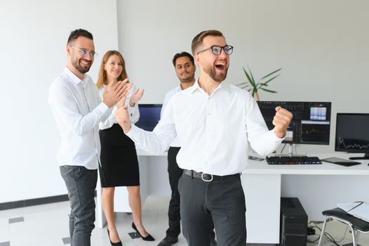 Portrait Of Young Handsome Businessman In Office With Colleagues in The Background photo