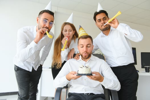 Surprise. Mixed race happy people celebrating a birthday of colleague in the modern office photo