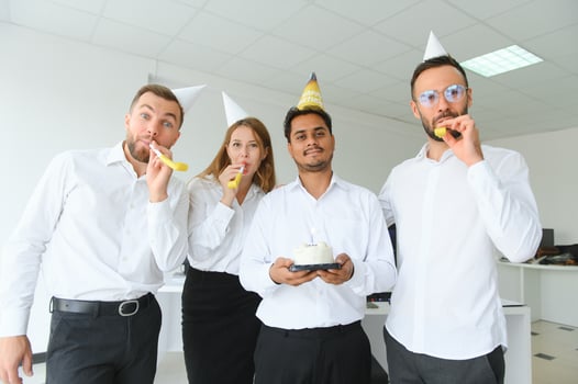 Surprise. Mixed race happy people celebrating a birthday of colleague in the modern office photo