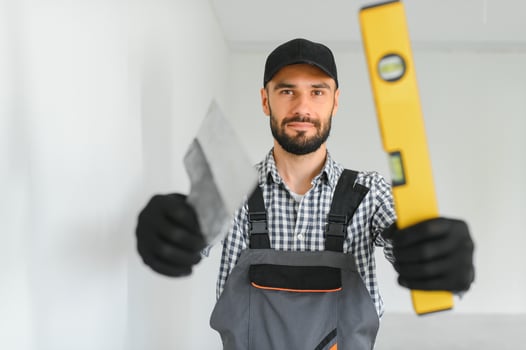 Portrait of a builder in the process of working on a construction site indoors photo