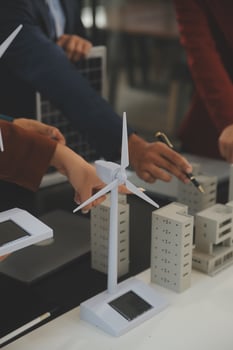 Close-up at tablet, Engineers pointing at tablet with their hands. To jointly design the use of renewable energy with wind and solar energy. Concept of using renewable energy. photo