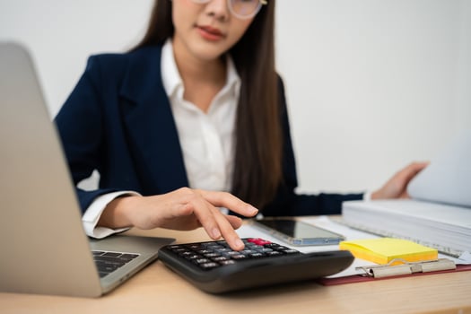 Portrait of smiling beautiful business asian woman at modern office desk using laptop to work and write notes, Business people employee freelance online marketing e-commerce telemarketing concept. photo