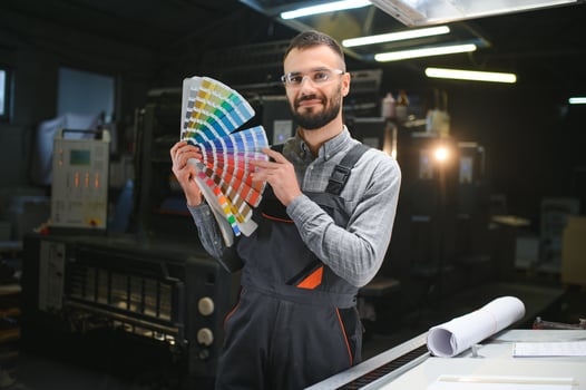 Graphic engineer or worker checking imprint quality in modern print shop photo