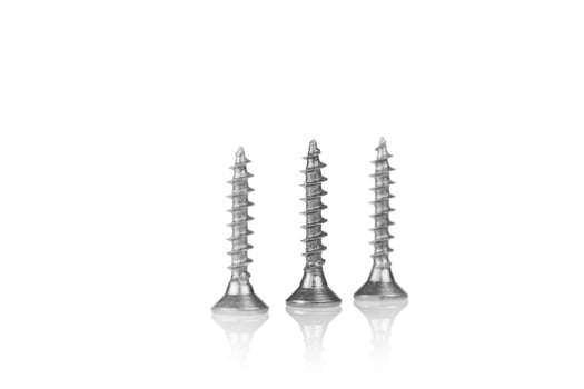 macro screw of silver color on a white background photo
