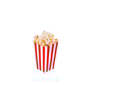 Glass with popcorn on a white background photo