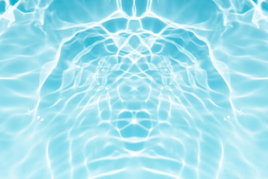 Blue sea waves on the surface ripples blurred. Defocus blurred transparent blue colored clear calm water surface texture with splash and bubbles. Water waves with shining pattern texture background. photo