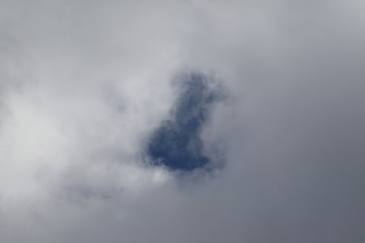 Cloudscape scenery, overcast weather above dark blue sky. Storm clouds floating in a rainy dull day with natural light. White and grey scenic environment background. Nature view. photo