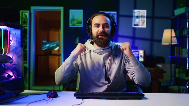 Esports player recording himself playing videogames in front of online viewers during livestream, providing engaging commentary while battling foes. Pro gamer streaming gaming session photo