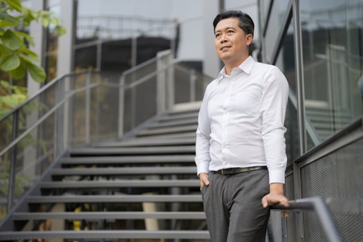 Confident businessman descending outdoor stairs photo