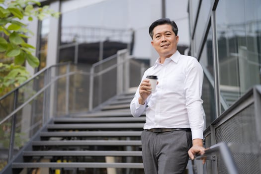Confident businessman descending outdoor stairs photo
