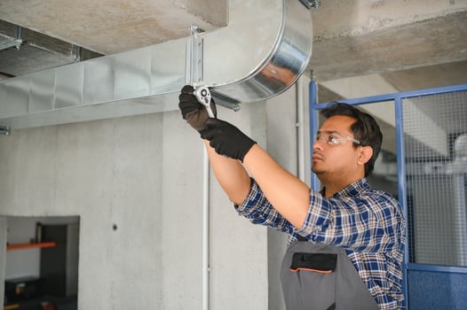 Ventilation cleaning. Specialist at work. Repair ventilation system. Industrial background photo