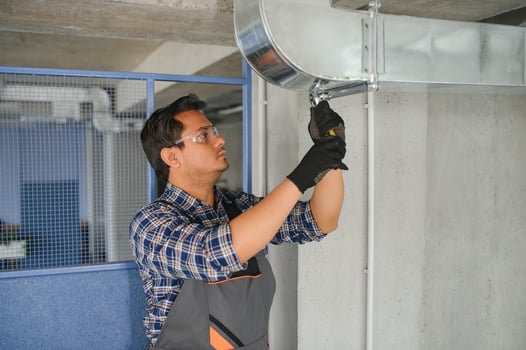 Ventilation cleaning. Specialist at work. Repair ventilation system. Industrial background photo