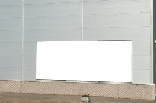 Billboard layout on the wall of the building. Gray city building with a billboard. photo