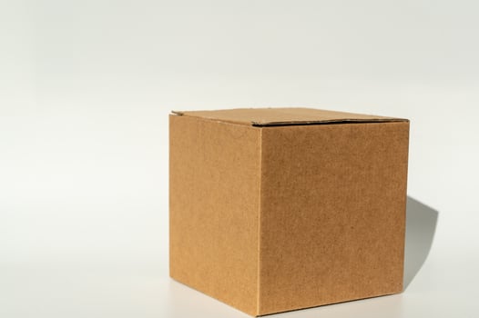 Simple brown cardboard box on white background. photo