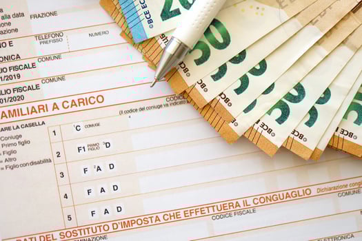 Filling italian tax form process with pen and euro money bills close up. Tax paying period photo