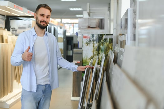 man choosing ceramic tiles and utensils for his home bathroom photo