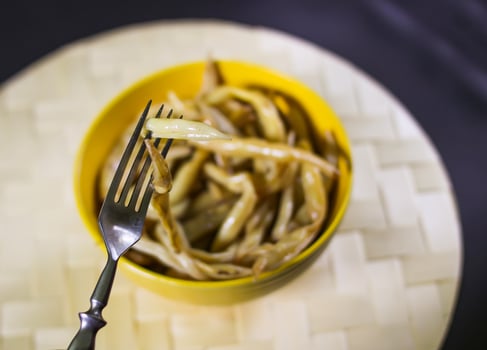 Fried long french beans in yellow ceramics cup. photo