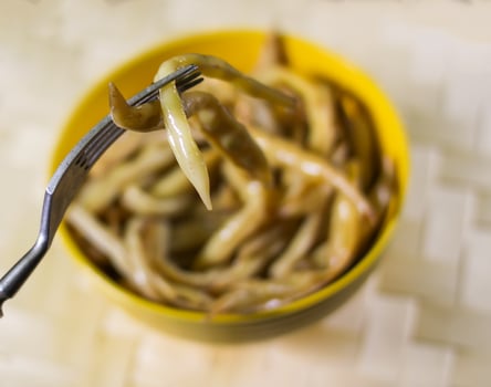 Fried long french beans in yellow ceramics cup. photo