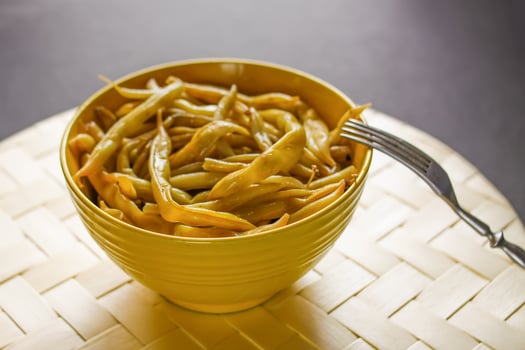 Fried long french beans in yellow ceramics cup. photo