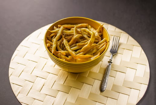 Fried long french beans in yellow ceramics cup. photo