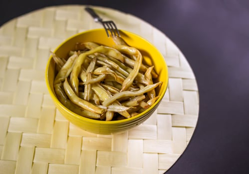 Fried long french beans in yellow ceramics cup. photo
