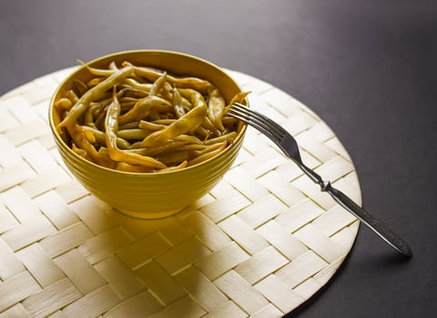 Fried long french beans in yellow ceramics cup. photo