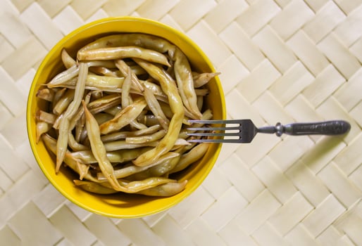 Fried long french beans in yellow ceramics cup. photo