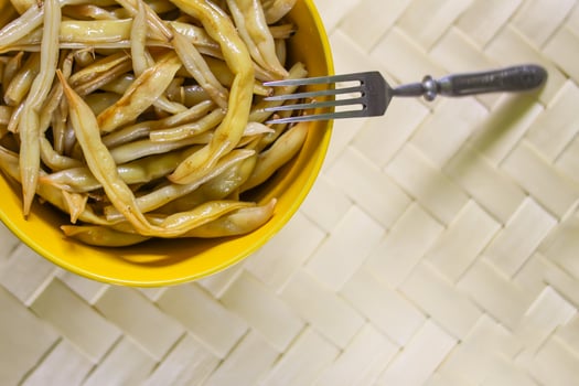 Fried long french beans in yellow ceramics cup. photo