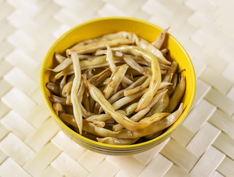 Fried long french beans in yellow ceramics cup. photo