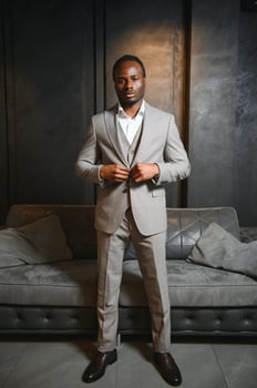 African man in a classic suit on a dark gray background. The concept of classic clothing photo