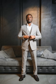 A handsome young african gentleman buying an elegant suit photo