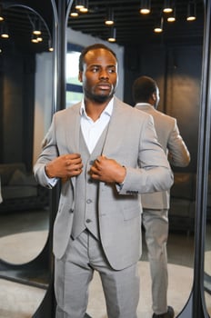 Young african man shopping in clothing store photo