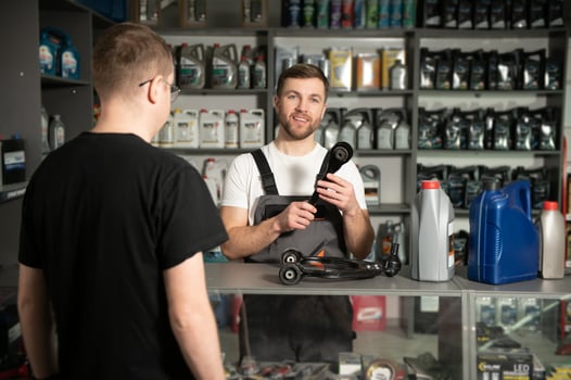 The seller selects new car repair parts for the client photo