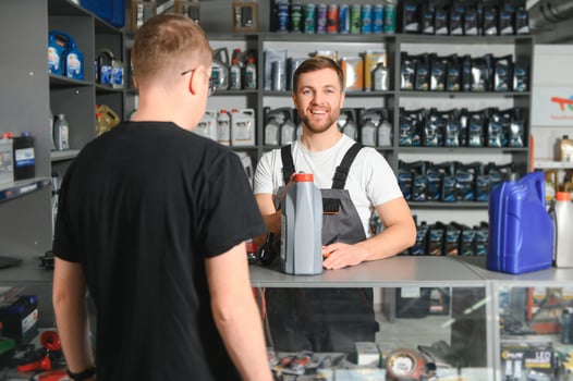 The seller selects new car repair parts for the client photo