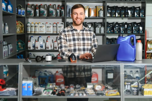 Portrait of a handsome salesman in an auto parts store. The concept of car repair photo